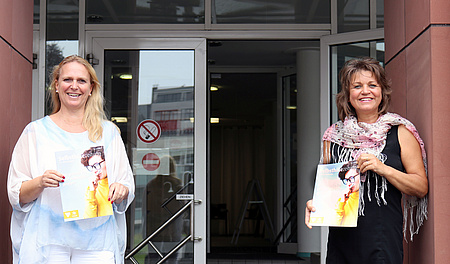 Erste Kreisbeigeordnete Stephanie Becker-Bösch und Anette Obleser von der Selbsthilfe-Kontaktstelle des Wetteraukreises stellen die 42. Selbsthilfezeitung vor